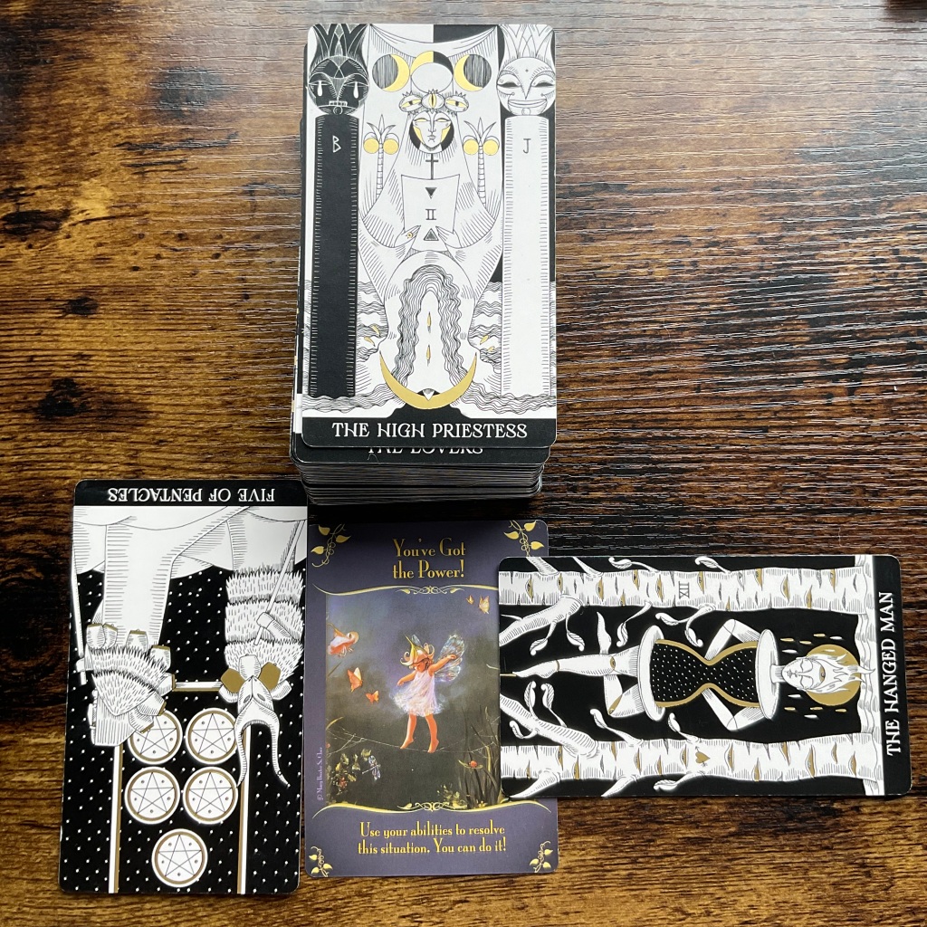 The High Priestess, Five of Pentacles and Hanged Man from the Symbolic Soul Tarot Deck and Magical Messages of Faries Oracle Cards